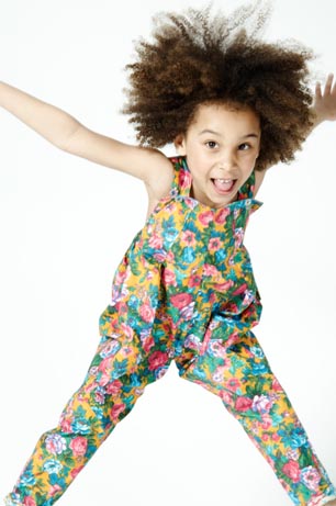 Girl wearing What Mother Made Floral Dungarees